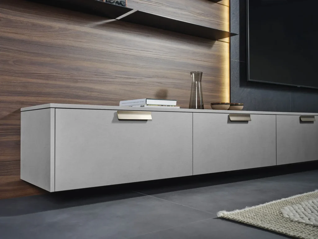 Graues Sideboard mit bronzefarbenen Griffprofilen