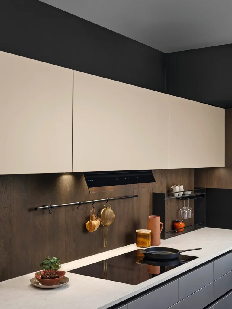 Graue Küchenzeile mit heller Arbeitsplatte und sandfarbenen Oberschränken