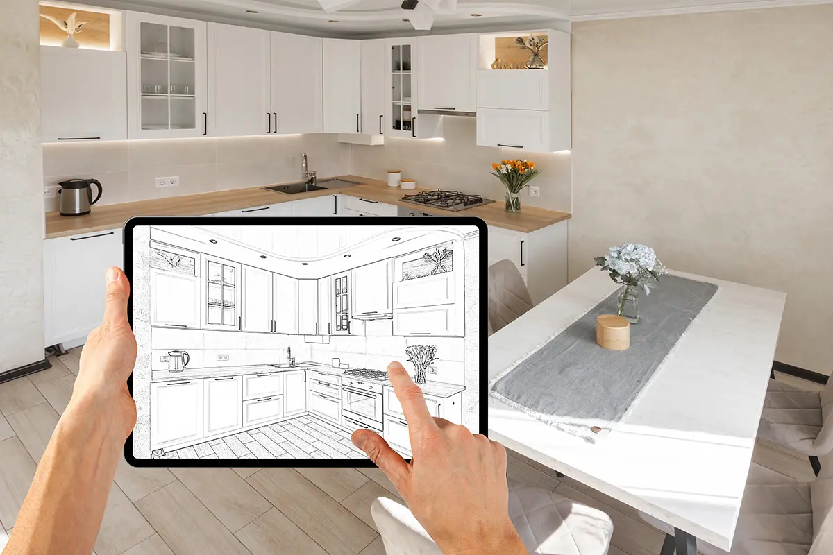 Eine Person hält ein Tablet mit einer Zeichnung einer modernen Küche